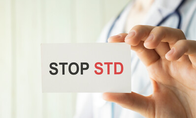 Doctor holding a card with text STOP STD medical concept