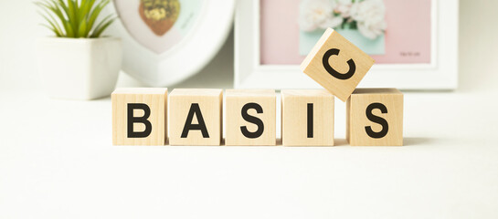 concept word BASIC on cubes on a striped blue background