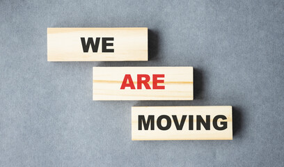 WE ARE MOVING word written on wood block. we have moved text on wooden table for your desing, concept.