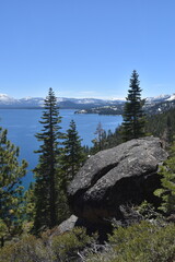 The turquoise azure blue Lake Tahoe and the surrounding mountains and forest 