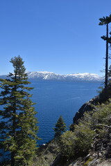The turquoise azure blue Lake Tahoe and the surrounding mountains and forest 