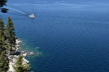 The turquoise azure blue Lake Tahoe and the surrounding mountains and forest 