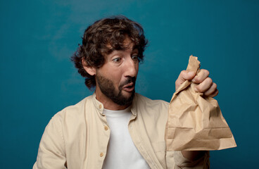 young adult bearded man with a paper bag