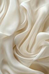 Obraz premium A close-up of smooth, flowing cream-colored fabric showcasing elegant draping.