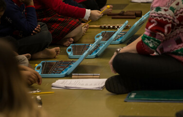 The children on the floor with music tools at school