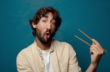 young adult bearded man with chopsticks