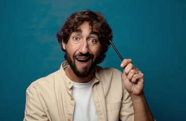 young adult bearded man with a pencil