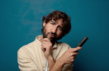 young adult bearded man with a remote control