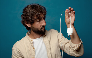 young adult bearded man smartphone charger concept
