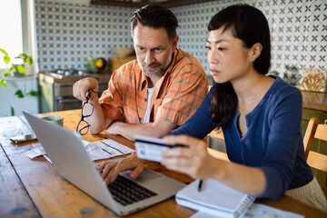 Happy couple online shopping at home