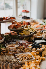 Close-Up of Gourmet Grazing Table with Cheese Cubes, Cashews, Crackers, Fresh Fruit, and Artisanal Bread for Weddings, Parties, and Luxurious Event Catering Inspiration