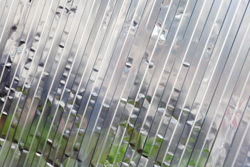 Corrugated shiny metal wall, industrial background texture