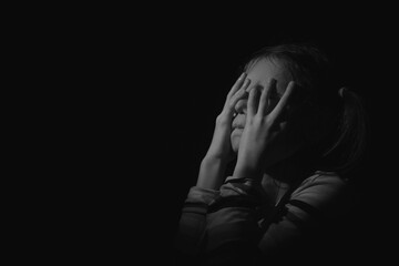Close up portrait of stressed, unhappy young adolescent girl crying and feeling exhausted or...