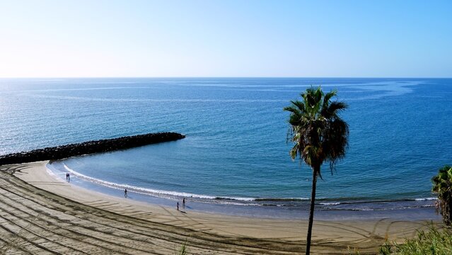 Retirees living in the Canary Islands in winter. Aerial view of Playa de Las Burras and San Agustin near Playa del Ingles in the south of Gran Canaria. Calm ocean on the horizon