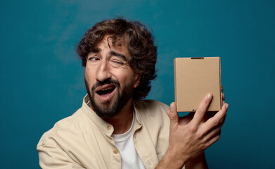 young adult bearded man with a cardboard box