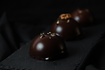 Delicious mousse cakes coated in chocolate glaze