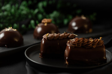 Delicious mousse cakes coated in chocolate glaze