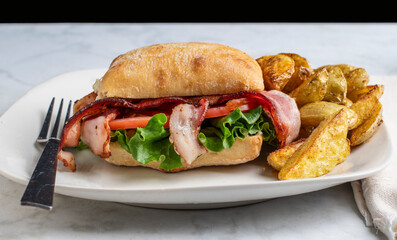 ciabatta blt sandwiches served with  a  side potato wedges,