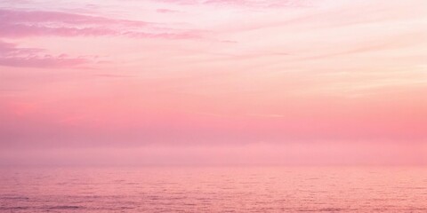 Obraz premium A Serene Seascape Bathed in the Soft Glow of a Pink and Orange Sunset