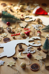 Various Christmas decorations in neutral colors on wooden background. Selective focus.