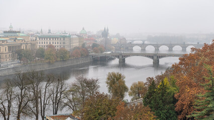 Bridges crossing the Vltava River in Prague on a day with thick fog, Czech Republic