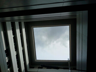 Fototapeta premium Low-angle, full shot of a square skylight. The open area within a multi-story building.