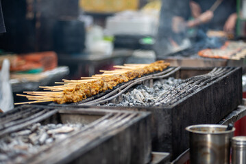 Meat Sticks on Barbecue For Street Food In The Center Of Singapore