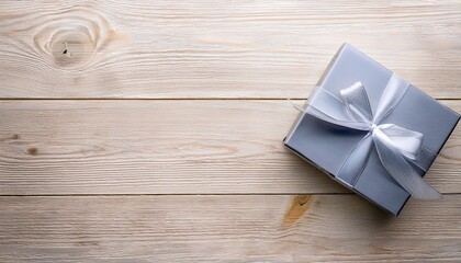 Gray Gift Box with Silver Ribbon on Wooden Background. Top View of Teacher Day Gifts with Copy Space
