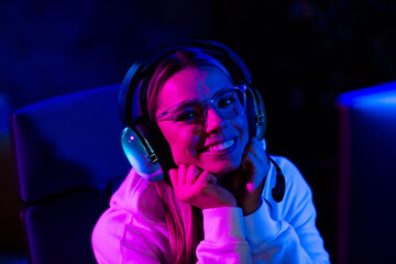 Photo of cute charming blonde girl look camera dreamy play gamer computer purple blue neon light...