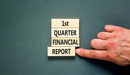 1st quarter financial report symbol. Concept words 1st quarter financial report on beautiful wooden blocks. Beautiful grey background. Business 1st quarter financial report concept. Copy space.