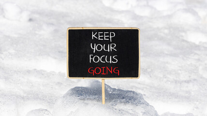 Keep your focus going symbol. Concept words Keep your focus going on beautiful black blackboard. Beautiful snow background. Business and keep your focus going concept. Copy space