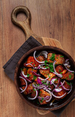 fried meat, pork kebab, ketsi in a clay pan, with red onions and herbs, homemade, no people,