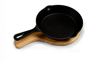 portioned cast iron frying pan, on a wooden stand, new, on a white background, isolate,