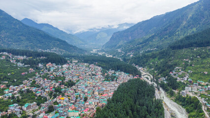 Aerial view of manali with the beas river in himachal pradesh India. Himalayan mountains and colourful local houses nestled in the hills of manali himachal pradesh India.