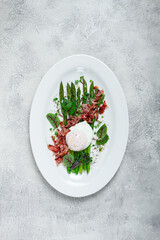 asparagus with poached egg and fried bacon, micro greens and spices, breakfast, homemade, no people,