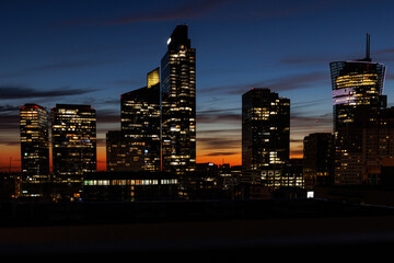Fototapeta premium Light in skyscraper offices at sunset
