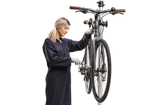 Female bike mechanic fixing a bicycle on a stand