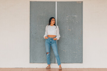 latin girl standing in the street full length with copy-space