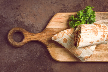 cut shawarma, 2 pieces, on a cutting board, close-up,