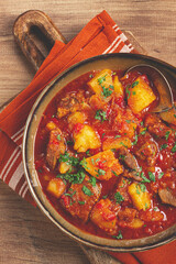 Potatoes with meat, stewed in tomato sauce, with spices and herbs, homemade, no people,
