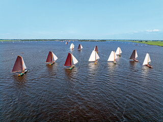 Aerial from historical wooden sailing boats, skutsjes on the Heegermeer in the Netherlands