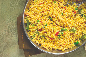 rice with saffron and vegetables, in a frying pan, top view, homemade, no people,