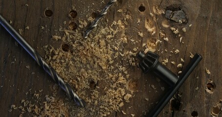Drill Bits and Wood Shavings on a Rustic Wooden Surface