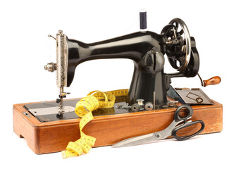 Sewing machine with measuring tape, scissors and spools of threads isolated on white