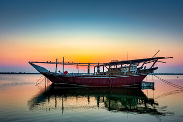 Obraz premium Boats on Dammam sea side with sunrise background view. Dammam, Saudi Arabia.