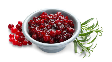 Tasty cranberry sauce in bowl, berries and rosemary isolated on white