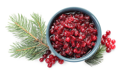 Tasty cranberry sauce in bowl, berries and fir branches isolated on white, top view