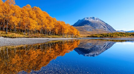 Naklejka premium A serene mountain lake, showcasing vibrant autumn colors reflected perfectly in the still water.