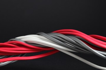 Many electrical wires on black background, closeup