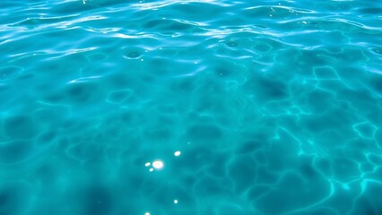 Obraz premium Crystal Clear Turquoise Water Surface with Sunlight Reflections